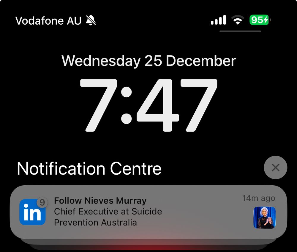 The notification screen on my phone, at 7:47am on Christmas Day. There is a notification from LinkedIn, suggesting I follow the Chief Executive of Suicide Prevention Australia.