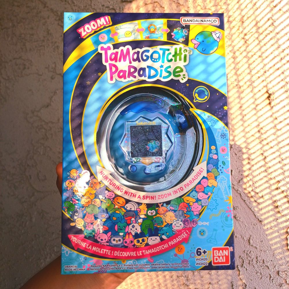 An Ocean Blue Tamagotchi Paradise in its box/packaging