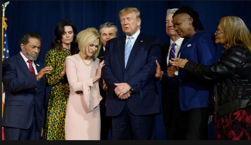 Michael Tait on stage with Trump and other faith leaders praying over Trump