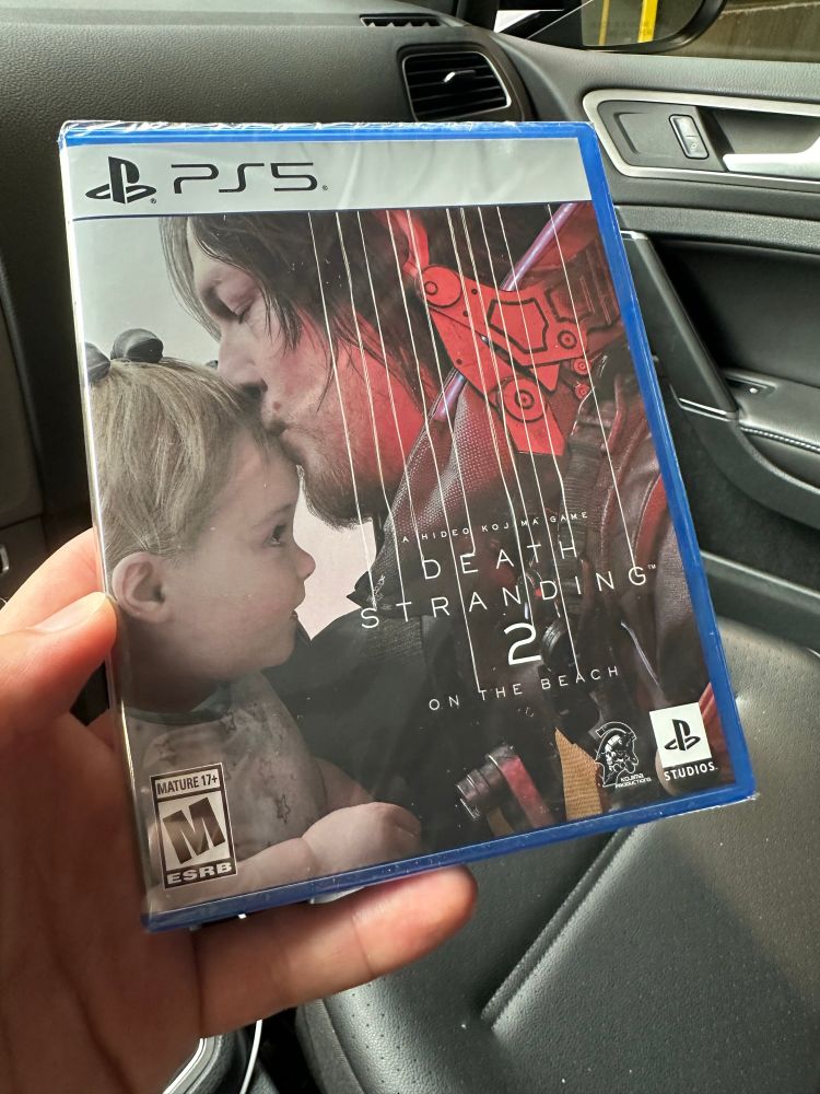 Death stranding 2 cover with Sam redus kissing a baby’s head. 