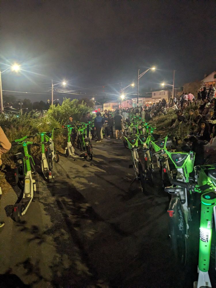 Burke Gilman trail in Seattle on July 4th lined with lime bikes and lime scooters. 