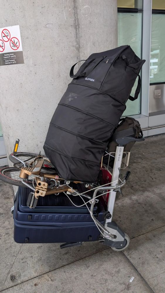 Lots of shit, on a luggage cart