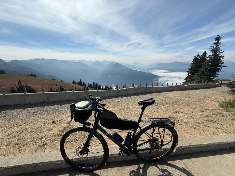 Bike leaning on curb at the top of a mountain