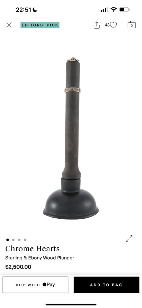 A black toilet plunger with a thick black handle and a silver decorative motif on the handle. It’s listed on TheRealReal for $2500. 