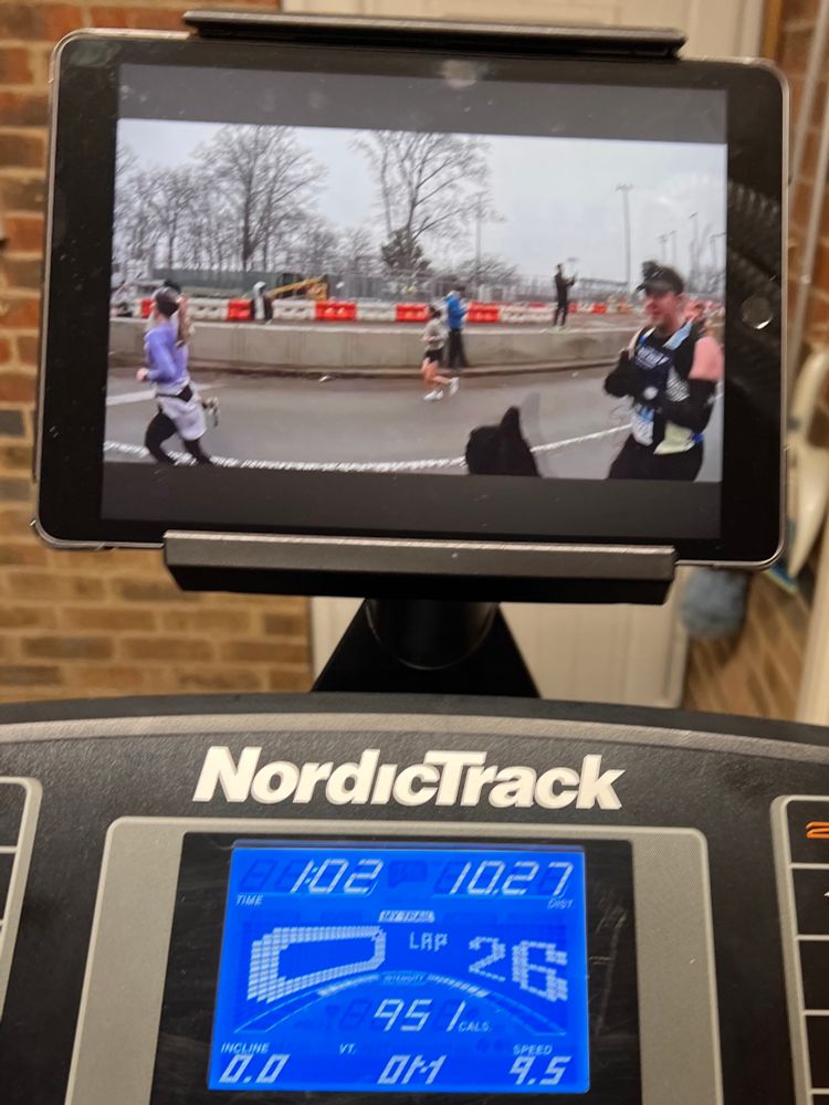 Photograph showing the display panel of a NordicTrack treadmill with an iPad attached to it. 