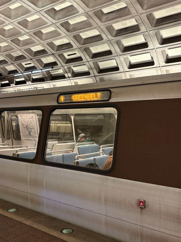 Metro train with Yellow glowing text indicating a yellow line train to “Greenbelt” at the Crystal City Metro platform