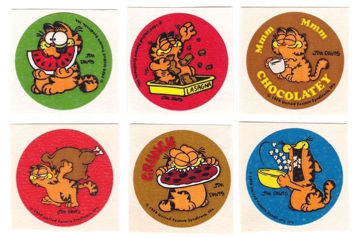 A photo of 3 columns of two rows or round stickers feature comical scenes of phrases and illustrations of the cartoon cat Garfield. 