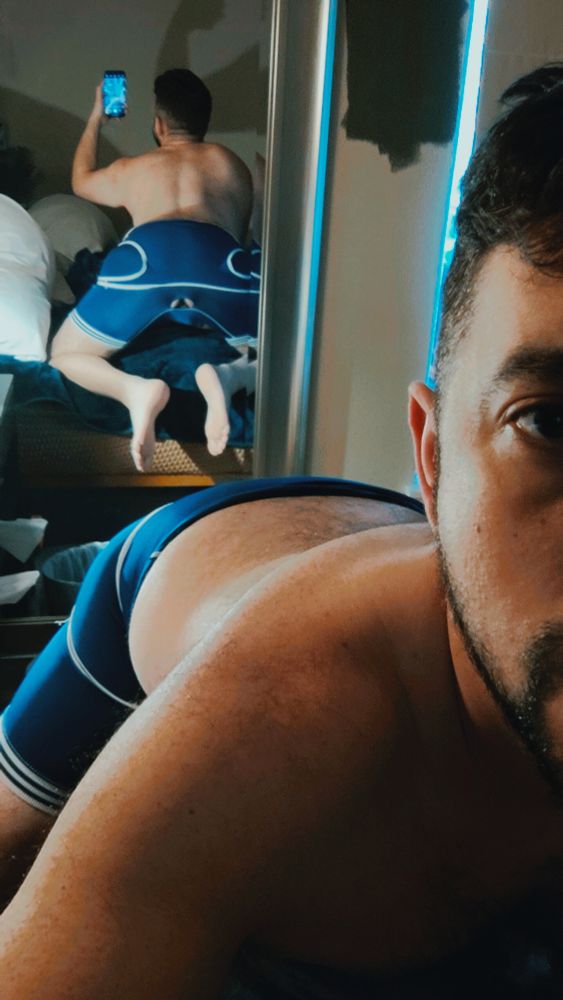 Picture of me taking a back shot of me with a blue pulled down singlet 