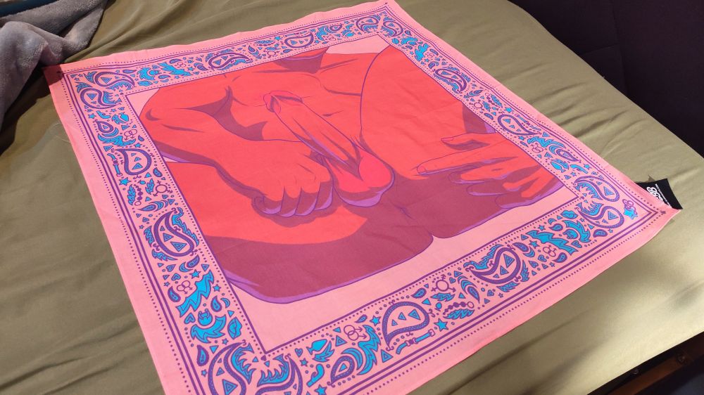 Picture of a bandana that is pink in color that features imagery of a man laying on his back showing his asshole and hard cock and balls. 