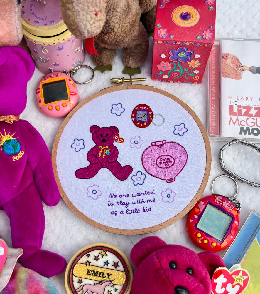 Hand embroidered hoop art of nostalgic 90s toys with lyrics from Taylor swifts mastermind, surrounded by said 90s toys 
