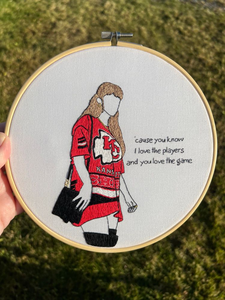 Hand embroidered decor of taylor swift at a chiefs game decked out in team gear 
