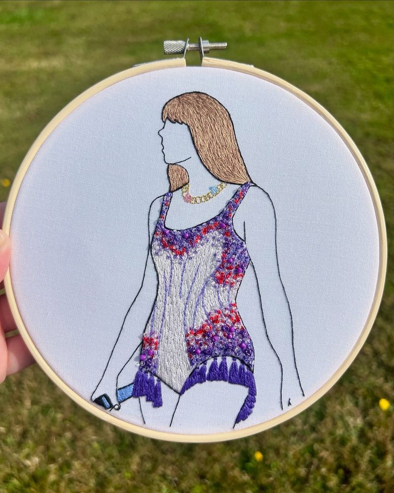 Hand embroidered decor of taylor swift wearing the purple lover bodysuit 