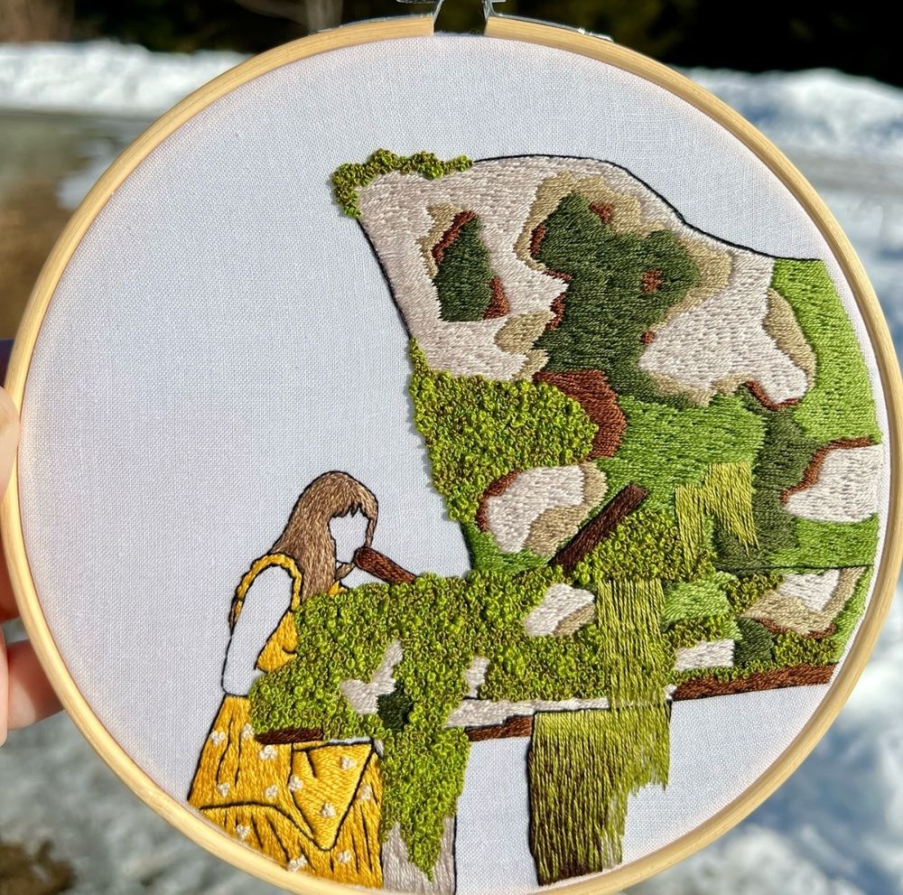 Hand embroidered hoop art of Taylor Swift performing champagne problems at the mossy piano on the eras tour, wearing the yellow/orange dress 