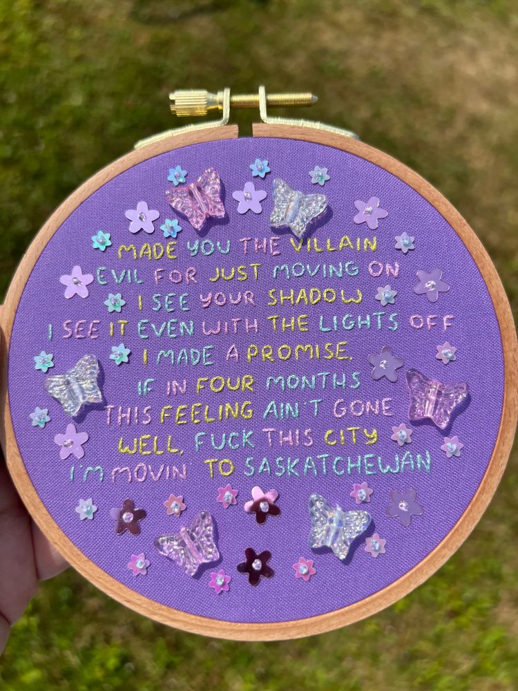 Hand embroidered hoop art of chappell roan the subway lyrics, stitched on purple cotton with glass butterfly beads and flower sequins 