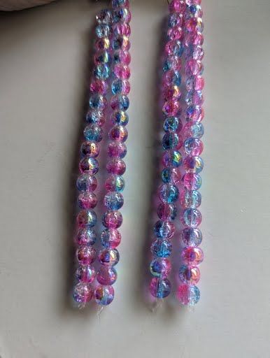 photo of strands of pink and blue crackly sparky beads