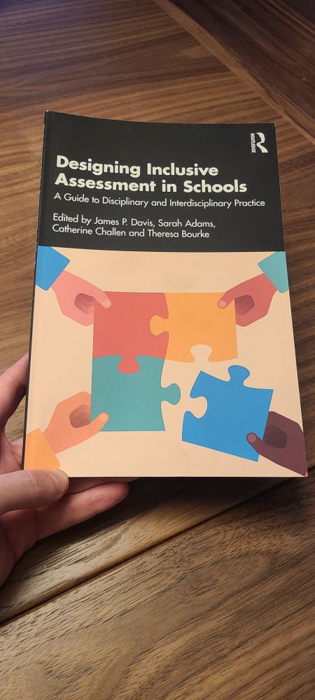 The photo pictures the cover to the book, Designing inclusive classroom assessment in schools. The cover features an image of several hands holding together different pieces to a puzzle, in alternating colours, beneath the book's title and author information. Full details are available at https://t.co/XnUoEzGtC6.