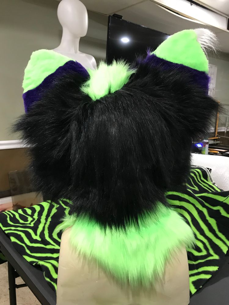 Green and purple hyena fursuit head.