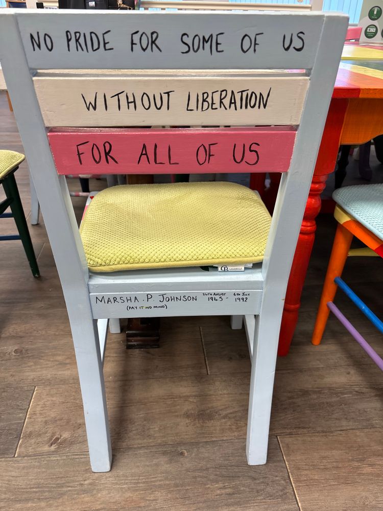 Light blue chair with the words “no pride for some of us, without liberation for all of us” 

A quote from Marsha P Johnson