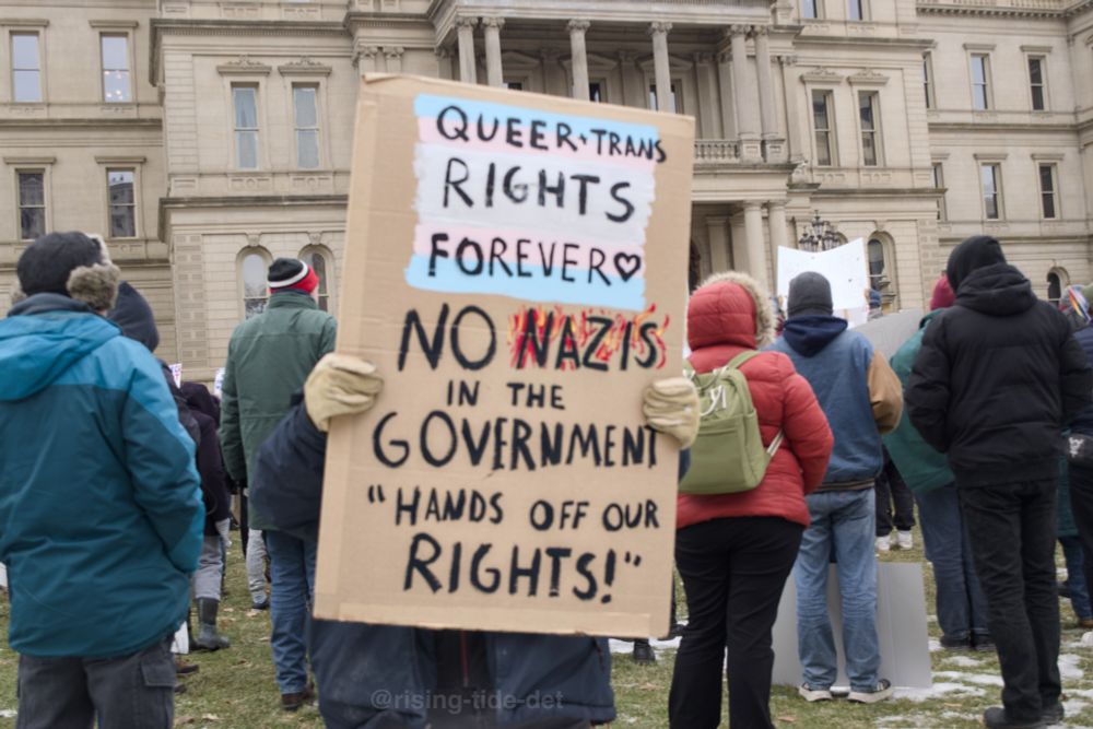 Protest sign: 

Queer + trans rights forever | No nazis in the government “hands off our rights!”