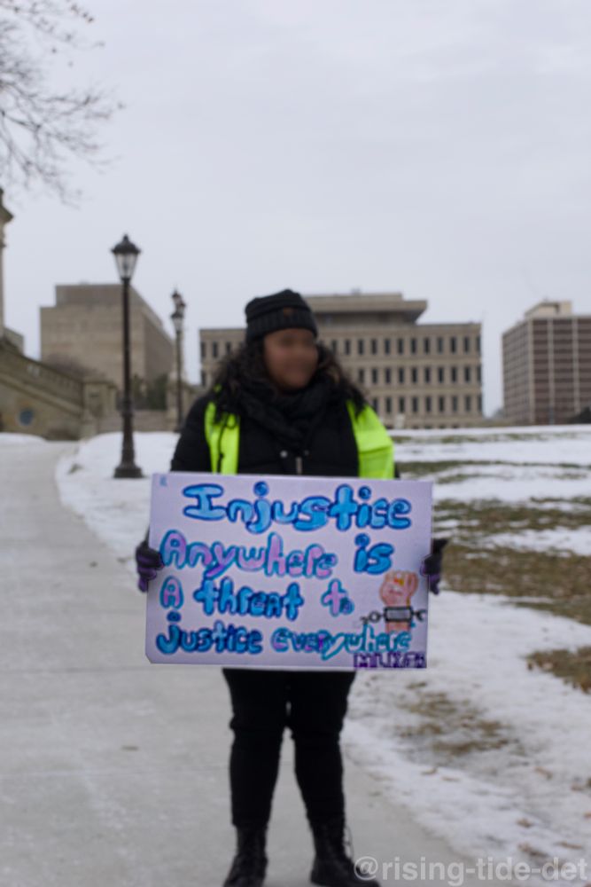 Protest sign: 

Injustice anywhere is a threat to justice everywhere - MLK

Also pictured, protester in a high vis vest