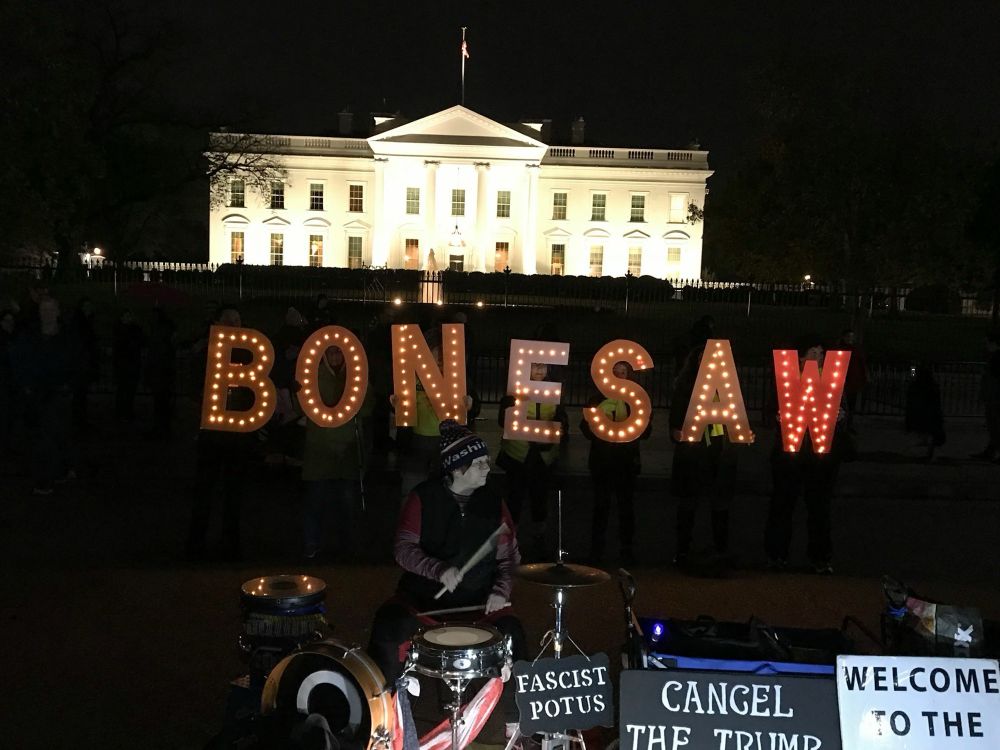 Activists hold sign BONESAW at Trump 1.0 White House following murder of Jamal Khashoggi 