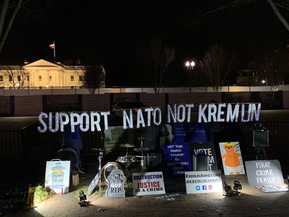Activists hold sign SUPPORT NATO NOT KREMLIN 