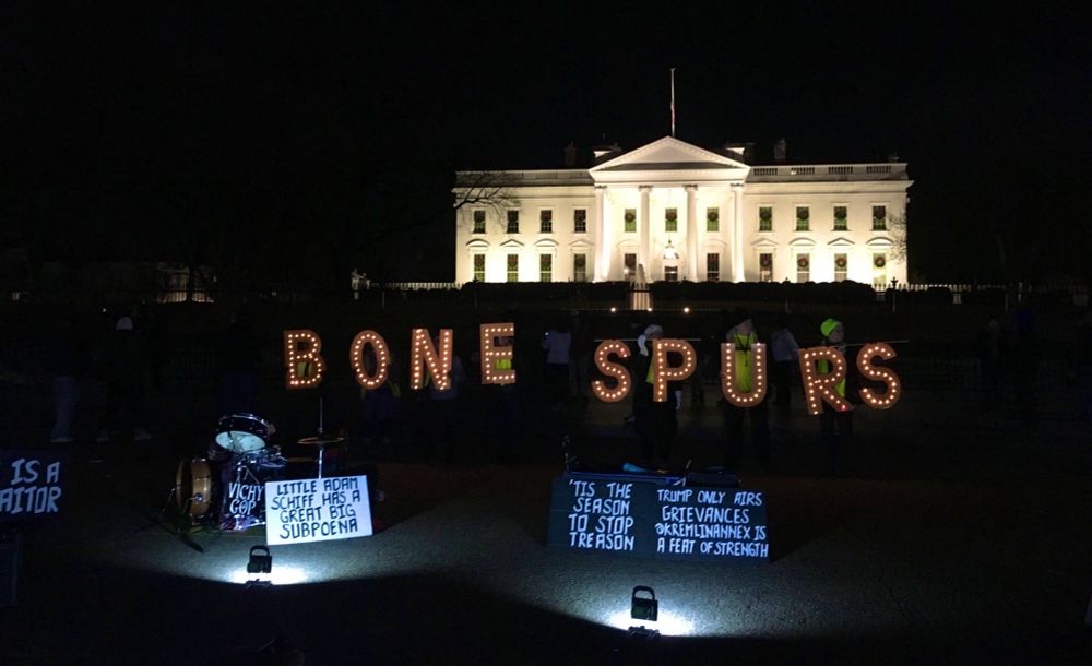 Activists hold sign BONE SPURS 
at Trump 1.0 White House 