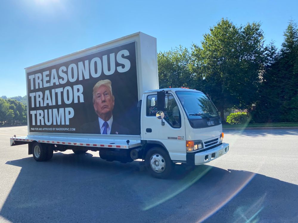 Truck w sign TREASONOUS TRAITOR TRUMP