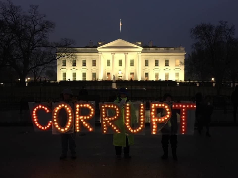 Activists hold sign CORRUPT at Trump 1.0 White House 