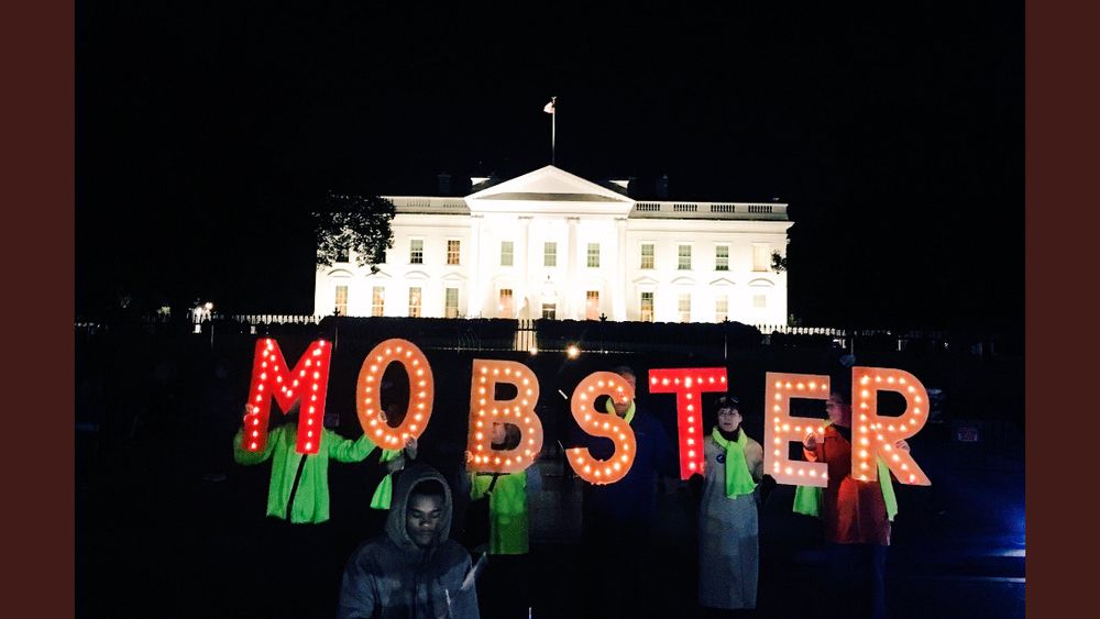 Activists hold sign MOBSTER at Trump 1.0 White House 