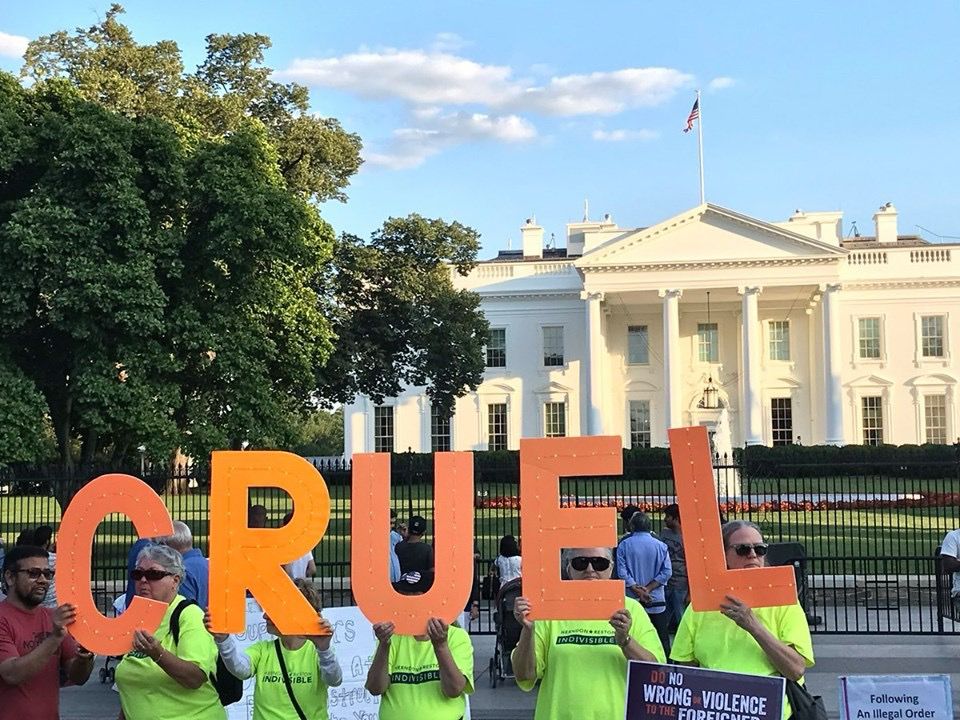 Activists hold sign CRUEL at Trump 1.0 White House 