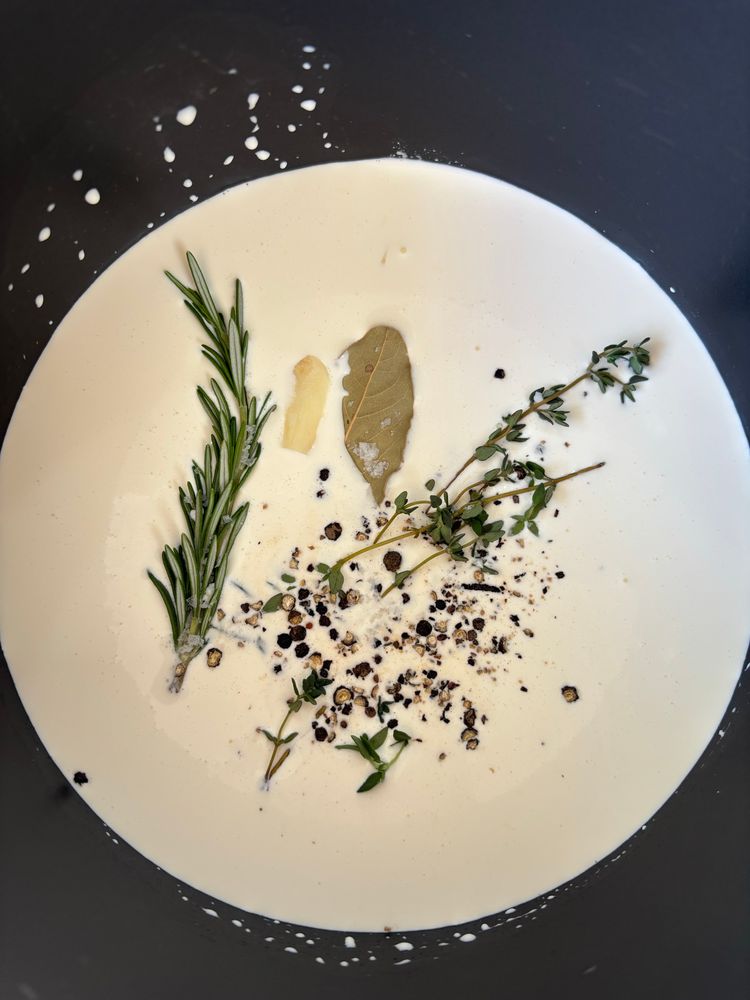 Herbs steeping is n cream & milk. 