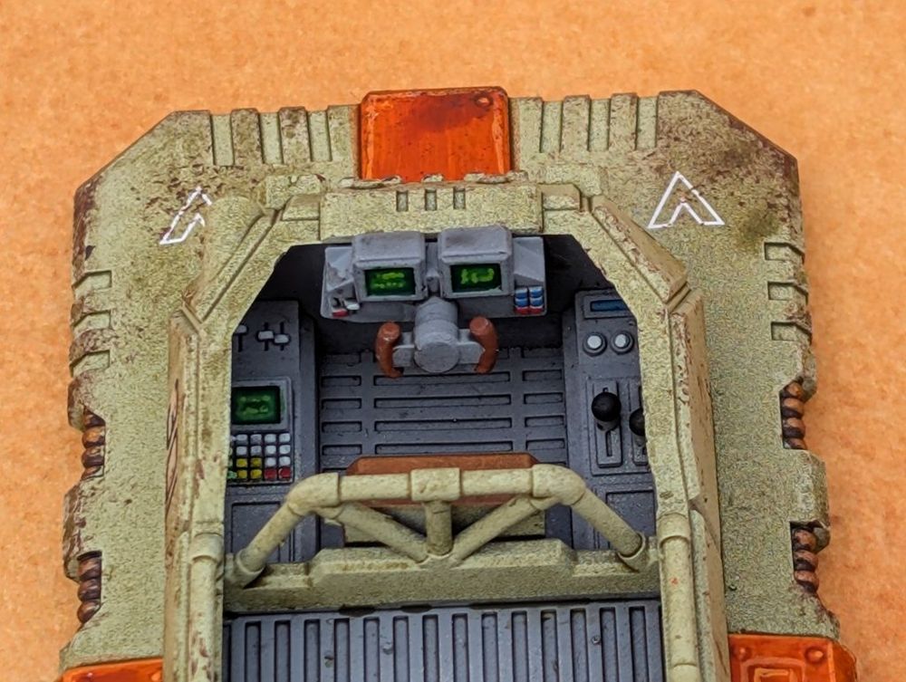 Interior of a 28mm scale vehicle cockpit showing displays and controls.