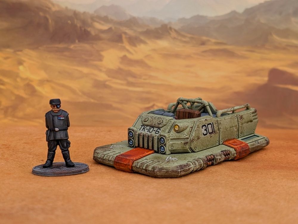 28mm sci-fi officer figure standing next to a grav vehicle in front of a desert backdrop.