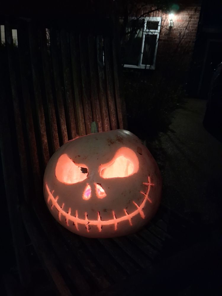 Jack Skellington pumpkin lit up.