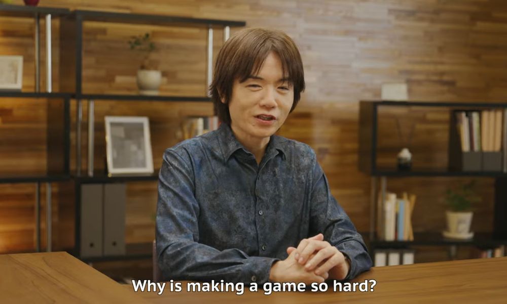 A picture of Mr. Sakurai with the caption of, "Why is making a game so hard?"