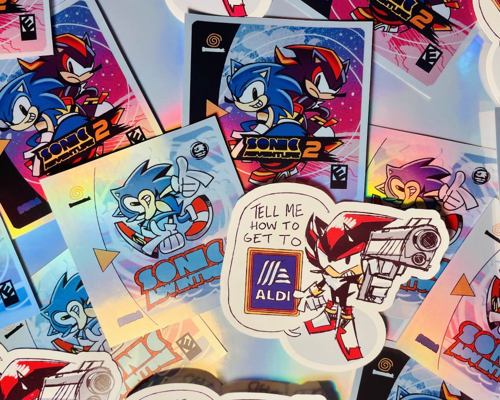 A photo of a spread of Sonic themed stickers. Some are holographics, with artwork featuring SA1, SA2 and Shadow. 