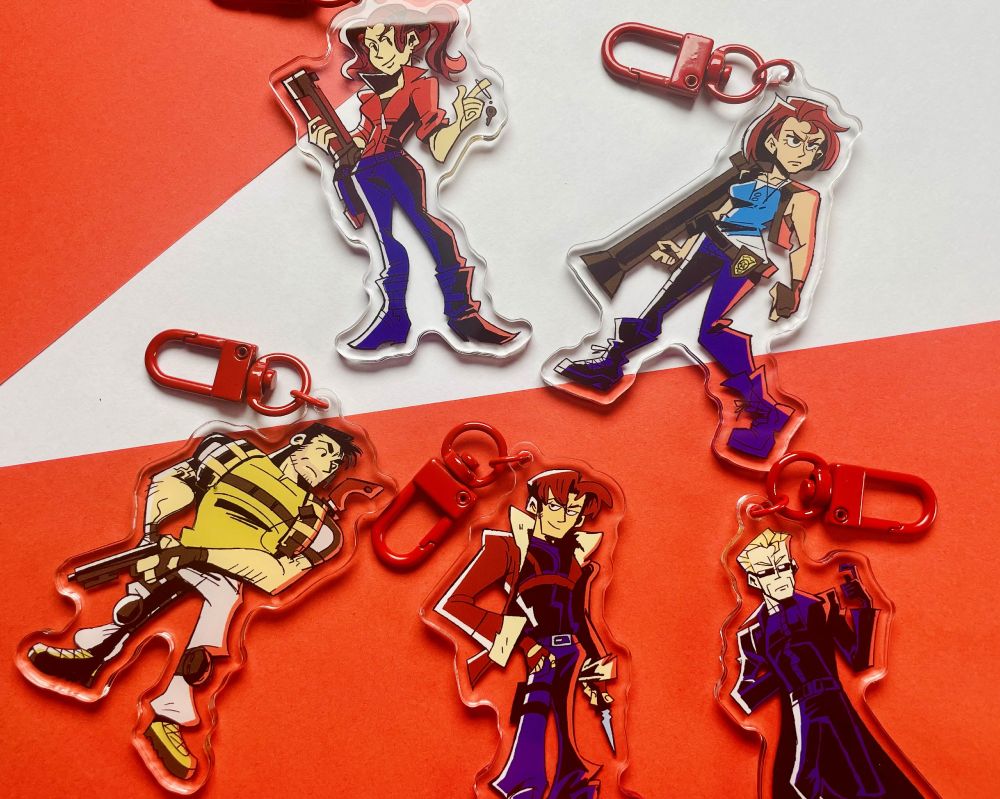 Photo of a set of RE character charms on a red and white background.