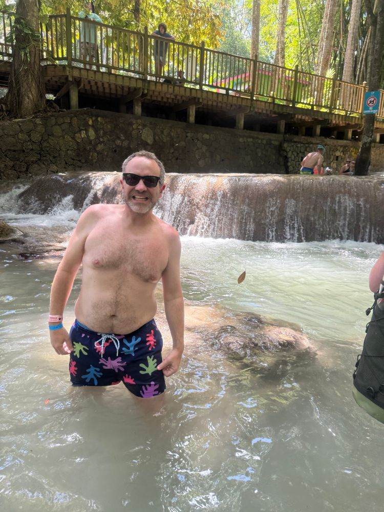 Me in Dunns River falls shirtless in suite that reminds me of sponge bob 