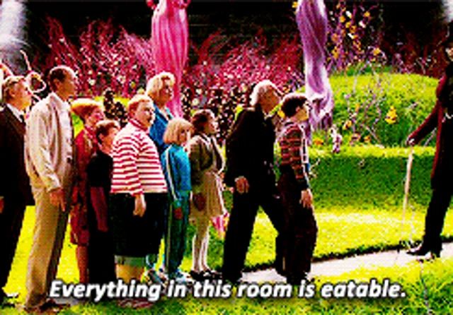 a group of people standing in a line with the words " everything in this room is edible "