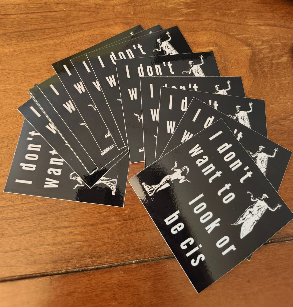 a spread of glossy black square stickers reading "I don't want to look or be cis" in stretched sans serif font, with two images of people from pre-Nazi German magazine Das 3 Geschlecht 