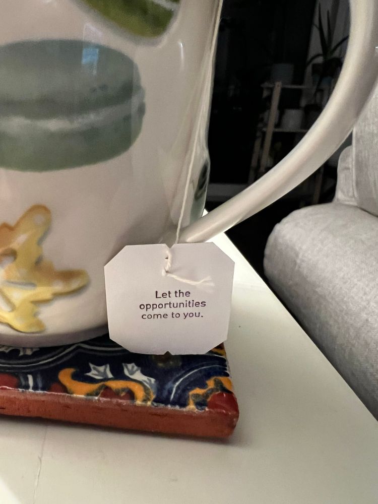 Close up of a tea tag that says, “let the opportunities come to you.” 