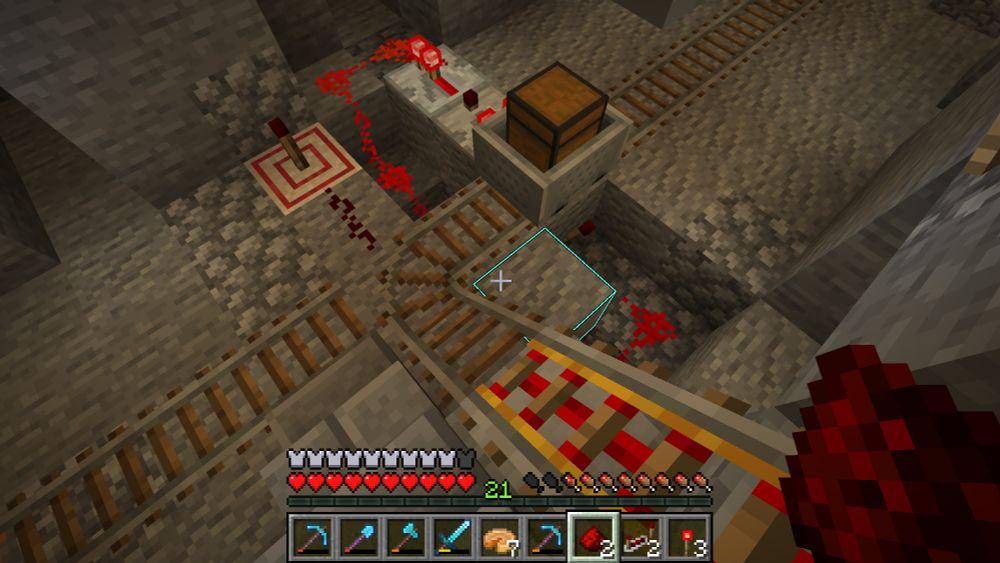 minecraft screenshot depicting a cart-with-chest sitting at a t-junction, which involves five redstone components plus ten or so lengths of dust just to switch the track