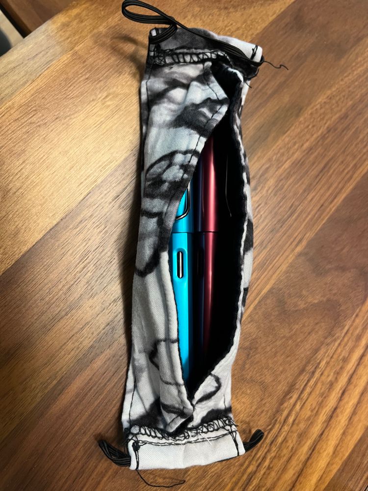 Fountain pens nestled into a box-style fabric mask. 