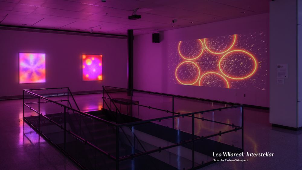 Custom LED panels on a museum wall glow with colorful purple and yellow abstract shapes, while illuminated circles are projected onto an adjacent wall at the Kalamazoo Institute of Arts