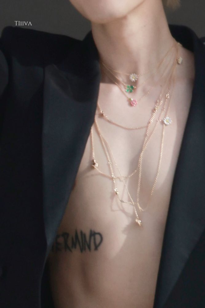 close up of jimin’s chest and you can see his nevermind tattoo and flower necklace stack clearly