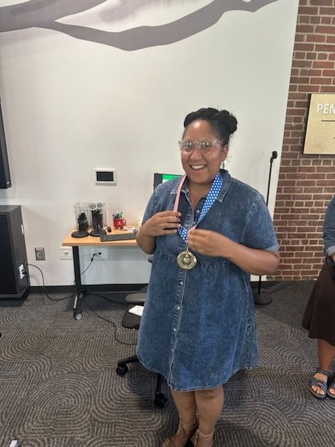 Tanisha standing with her gold medal!