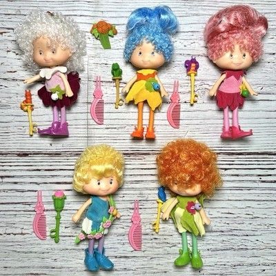 A photo of five "vintage" Herself the Elf dolls. Snowdrop is on the top left, she was my favourite. I can't remember the names of the next two. The bottom row left is Herself, and the redhead is Meadowmorn, I believe.