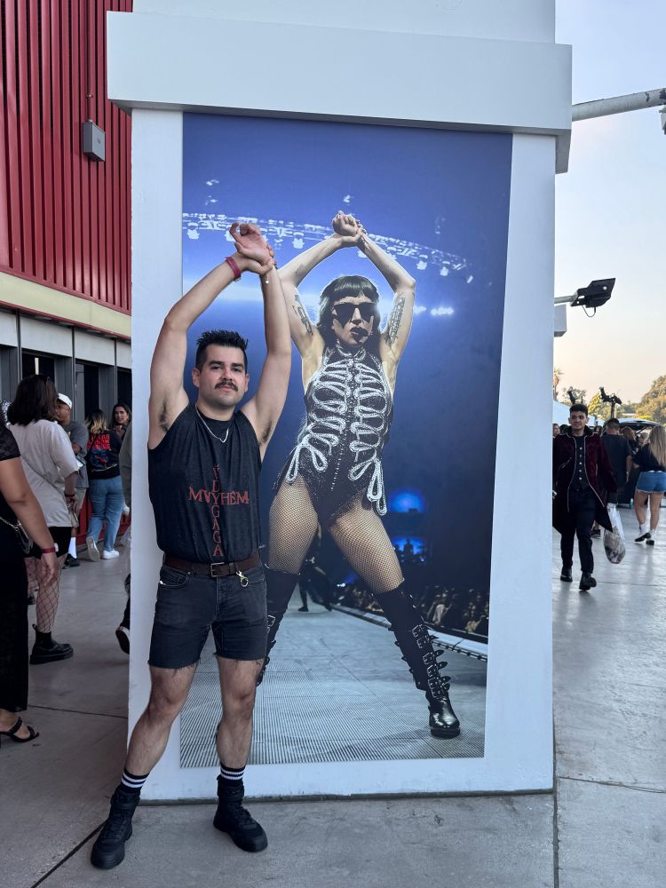 Man posing in front of Lady Gaga image