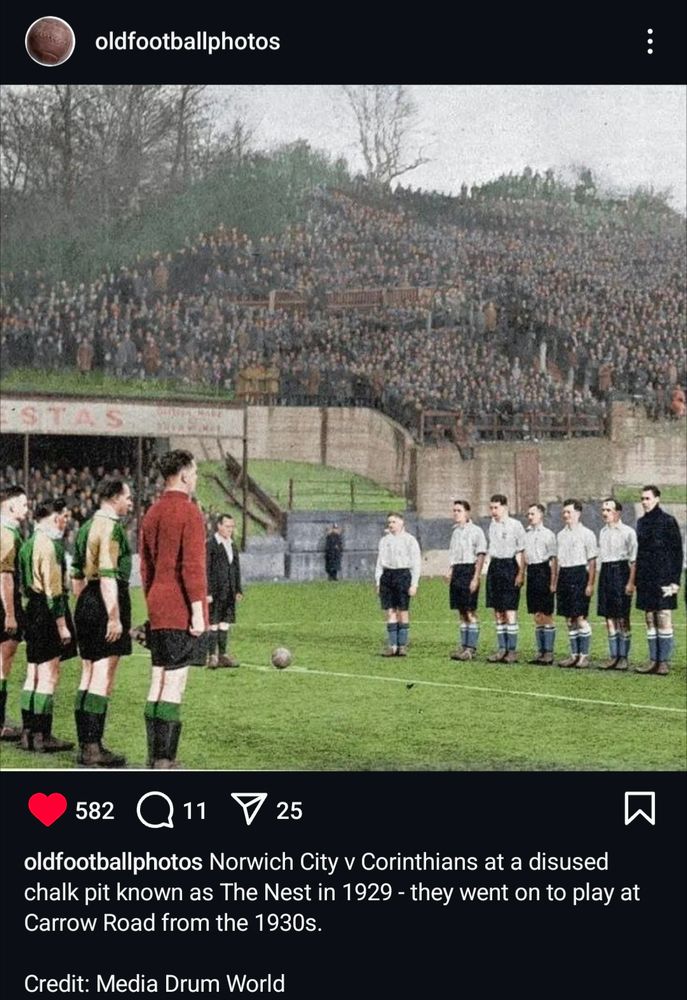 An Instagram post from account @oldfootballphotos showing a photo of English football team Norwich City & Brazilian team Corinthians lining up before an exhibition game in 1929. The venue for the match was a disused chalk pit which had been converted into a makeshift football ground. Masses of people are standing on a hill in the background.